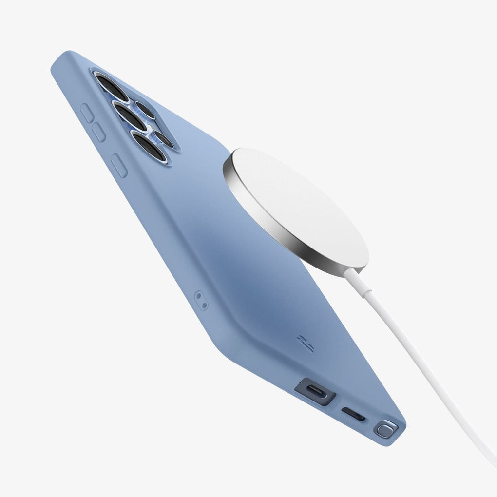 ACS09018 - Galaxy S25 Ultra Case Silicone Fit (MagFit + Qi2 Ready) in Sapphire Blue showing the back of the magsafe charger hovering above the back of the device with the case on showing partial side and bottom