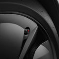 ACP11370 - Universal Tire Valve Stem Cap | VS100TS/R in silver installed on a wheel, highlighting the hexagonal cap with a red Tesla logo detail.