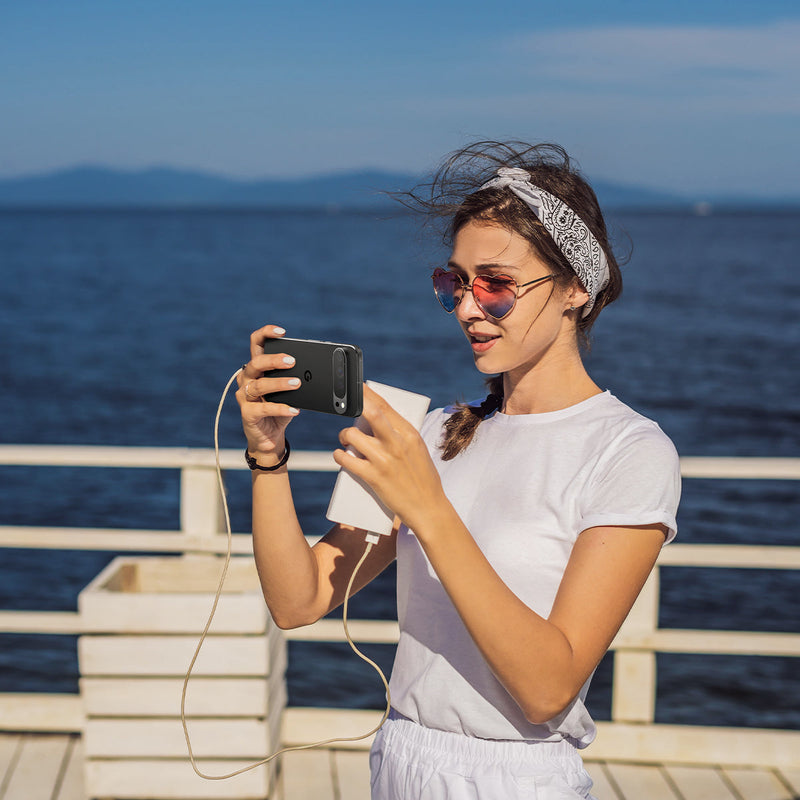 AGL08444 - Pixel 9 Case Optik EZ Fit Lens Protector in Crystal Clear showing a woman holding the device with the installed lens protector